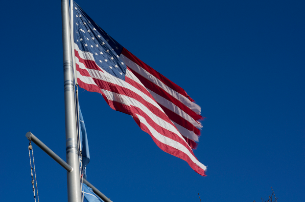 Eine amerikanische Flagge ist auf der linken Seite des Bildes positioniert.