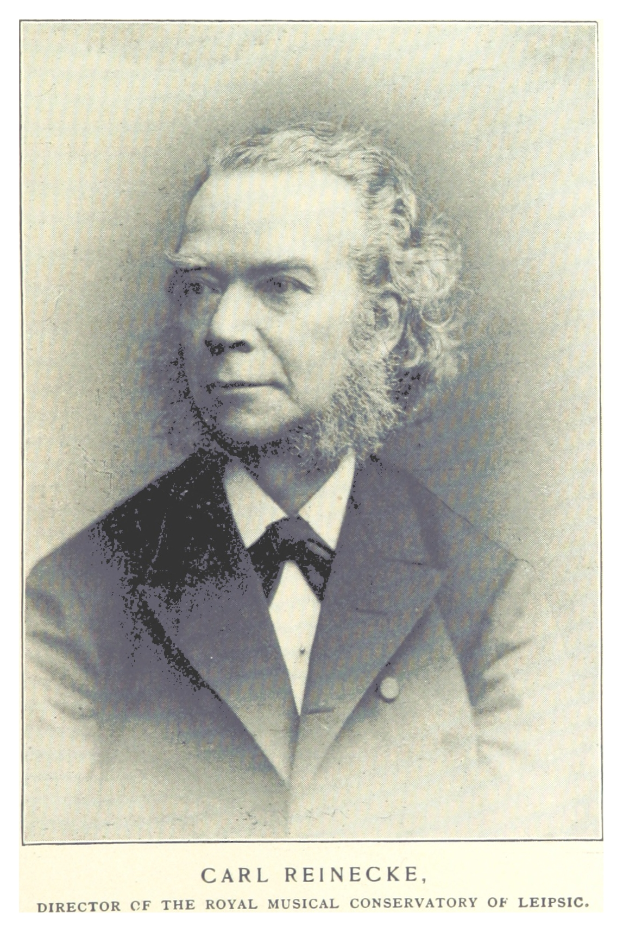 Ein Schwarz-Weiß-Foto von Carl Reinecke, dem Direktor des Königlichen Musikalischen Konservatoriums Leipzig, der einen Anzug trägt, mit Text unten im Bild.